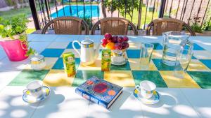 a table with a plate of fruit on it at Villa Andrea Cortes de la Frontera by Ruralidays in Cortes de la Frontera