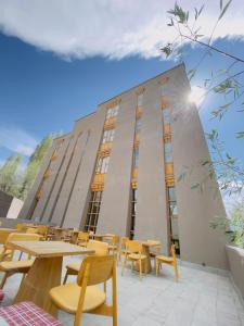 a building with tables and chairs in front of it at Chospa Hotel, Leh in Leh