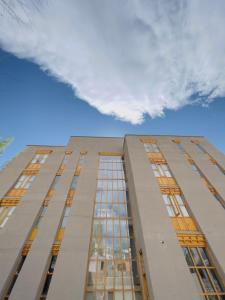 a tall building with windows on the side of it at Chospa Hotel, Leh in Leh