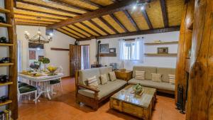 a living room with a couch and a table at Casa Entreolivos Casa y Cabana Cijuela by Ruralidays in Granada