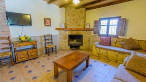 a living room with a couch and a fireplace at Villa el Establo Montefrio by Ruralidays in Montefrío