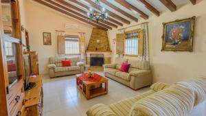 a living room with a couch and a fireplace at Cortijo Metomela Torrox by Ruralidays in Frigiliana