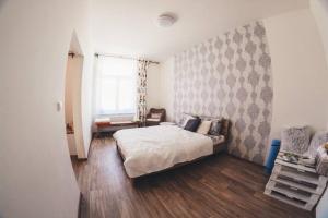 1 dormitorio con cama y sofá en Stylový apartmán v centru Náchoda, en Náchod