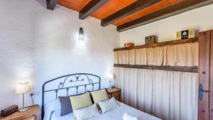 a bedroom with a blue bed and a window at Casa Jara de El Gastor by Ruralidays in El Gastor +14 photos