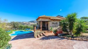 a house with a swimming pool and a resort at Casa Jara de El Gastor by Ruralidays in El Gastor