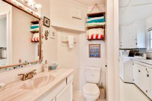 a bathroom with a sink and a toilet and a mirror at Spyglass Beach House in Freeland +34 photos