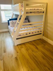 Ce lit superposé pour enfants se trouve dans un dortoir doté de parquet. dans l'établissement Luxurious Beach Front Apartment in Portrush, à Portrush