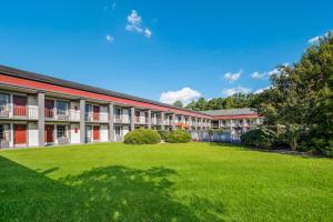 an exterior view of a school building with a large yard at Red Roof Inn Savannah - Richmond Hill I-95 in Richmond Hill