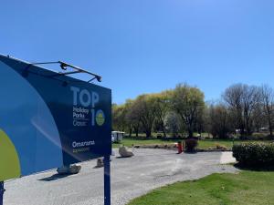 una señal en un estacionamiento junto a un parque en Omarama TOP10 Holiday Park, en Omarama