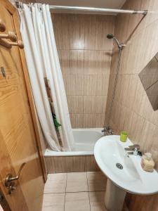 a bathroom with a sink and a shower and a tub at A los Soles de Fuerteventura in Costa de Antigua