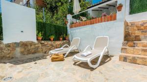 a group of chairs sitting on a patio at Casa Los Bancales Cortes de la Frontera by Ruralidays in Cortes de la Frontera