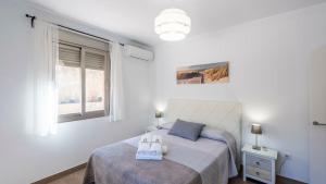 a bedroom with a bed with slippers on it at Casa El Hoyillo El Gastor by Ruralidays in El Gastor +32 photos