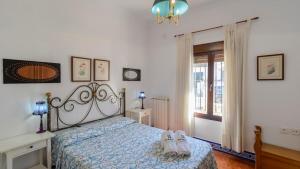 a bedroom with a bed with shoes on it at Casa El Torero El Bosque by Ruralidays in El Bosque +25 photos