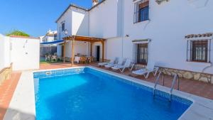 a swimming pool in front of a house at Casa El Torero El Bosque by Ruralidays in El Bosque