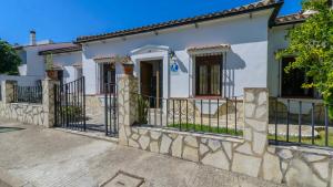 a white house with a black fence at Casa El Torero El Bosque by Ruralidays in El Bosque