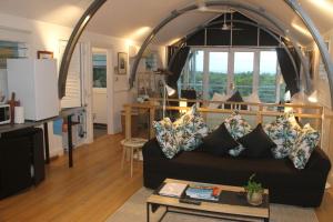 a living room with a couch and a table at SEAVIEWS Oak Beach in Oak Beach