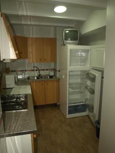a kitchen with a refrigerator and a tv on the ceiling at San Antón in Cazorla