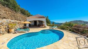 ein Swimmingpool in einem Hof mit einem Haus in der Unterkunft Finca Algarabia Competa by Ruralidays in Cómpeta