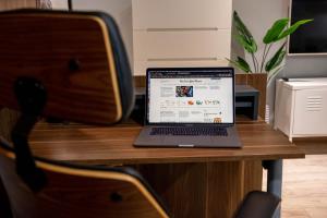 a laptop computer sitting on top of a wooden table at Smart Executive in Kraków