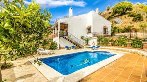 a house with a swimming pool in front of a house at Casa El Algarrobo Alora by Ruralidays in Alora