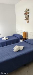 2 camas con sábanas azules en una habitación en Apartamentos Cala Azul La Móra, en Tarragona