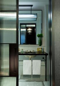 a bathroom with a sink and a mirror at Refinery Hotel - New York in New York