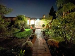 a garden at night with a walkway in front of a house at 华人区花园别墅 in Temple City