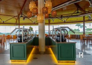 a row of wine machines in a room with tables at Hillary Nature Resort & Spa All Inclusive in Arenillas