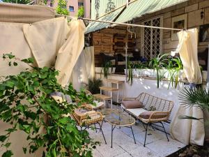 een patio met 2 stoelen en een tafel en stoelen bij Home Garden Rome Casa Kangen in Rome