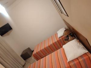 Un pat sau paturi într-o cameră la Pousada Águas de Caxambu