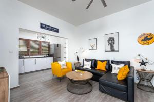 a living room with a couch and a table at Villa Chica 3 min to Beach, Diving & Restaurants with Pool and private Garden 10 min to Windsurfing & Kitesurfing in Belnem