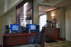 a office with two computer monitors on a desk at Howard Johnson by Wyndham Clifton NJ in Clifton