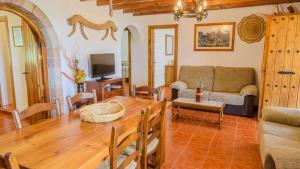 a living room with a table and a couch at Cortijo La Monja Antequera - La Higuera by Ruralidays in Antequera