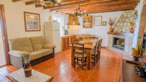 a living room with a couch and a table and a kitchen at Cortijo La Monja Antequera - La Higuera by Ruralidays in Antequera
