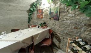 a dining room with a table with wine bottles at Vila Strážan in Poprad