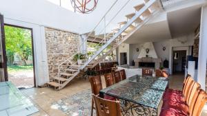阿奇多納的住宿－Cortijo La Vega Archidona by Ruralidays，一间带桌椅和楼梯的用餐室