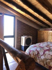a bedroom with a bed and a brick wall at Solanas de Uspallata in Uspallata +41 photos