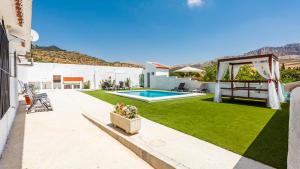 a backyard with a swimming pool and grass at El Llano del Torcal Antequera - La Higuera by Ruralidays in Antequera