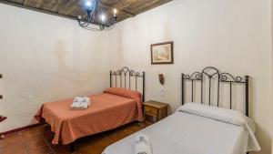 A bed or beds in a room at Casa Rural Azahar Periana by Ruralidays