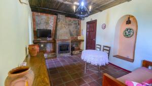 A television and/or entertainment centre at Casa Rural Azahar Periana by Ruralidays