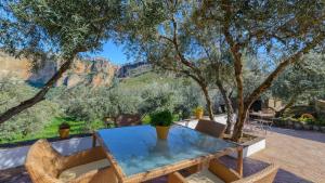 a glass table with a view of the canyon at Casa El Puente Ronda by Ruralidays in Ronda