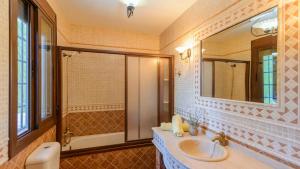 a bathroom with a sink and a mirror at Villa Rocio Setenil de las Bodegas by Ruralidays in Setenil