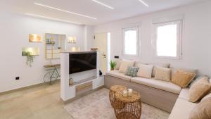 a living room with a couch and a tv at Maria's Head Villa Torre del Mar by Ruralidays in Torre del Mar