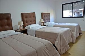 Кровать или кровати в номере Trinidad Inn Flores