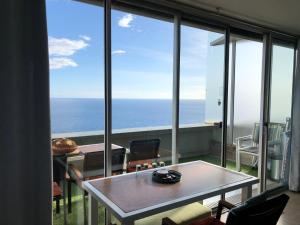 a room with a table and a view of the ocean at Viangella - Dramatic sea view! Top floor 2km to Monaco in Cap d'Ail