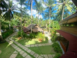 an aerial view of a resort with palm trees at Keyun's Inn- Across Cloud 9 in General Luna