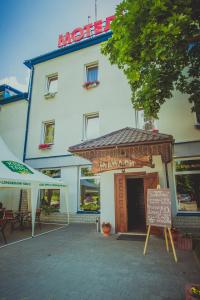 a restaurant with a sign in front of a building at Formula 1 in Ivano-Frankivsʼk