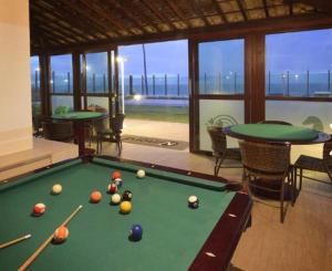 a room with a pool table with balls on it at Apartamento em Tabatinga in Conde
