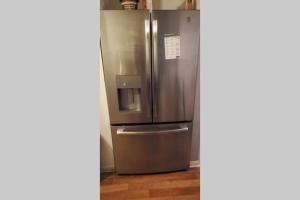 a stainless steel refrigerator sitting in a kitchen at Southern Charm Vacation Rental in Savannah
