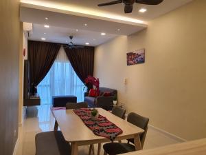 a dining room with a table and chairs at Southville Stay 2 @ Savanna Executive Suite in Kampong Tangkas